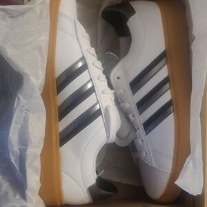Adidas Women White Sneakers with Black Stripes and Tan Soles.